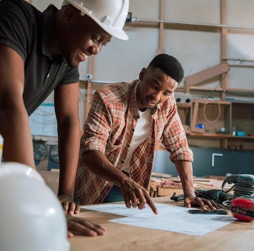 two-young-energetic-african-craftsmen-busy-discussing-there-new-project_720544-397